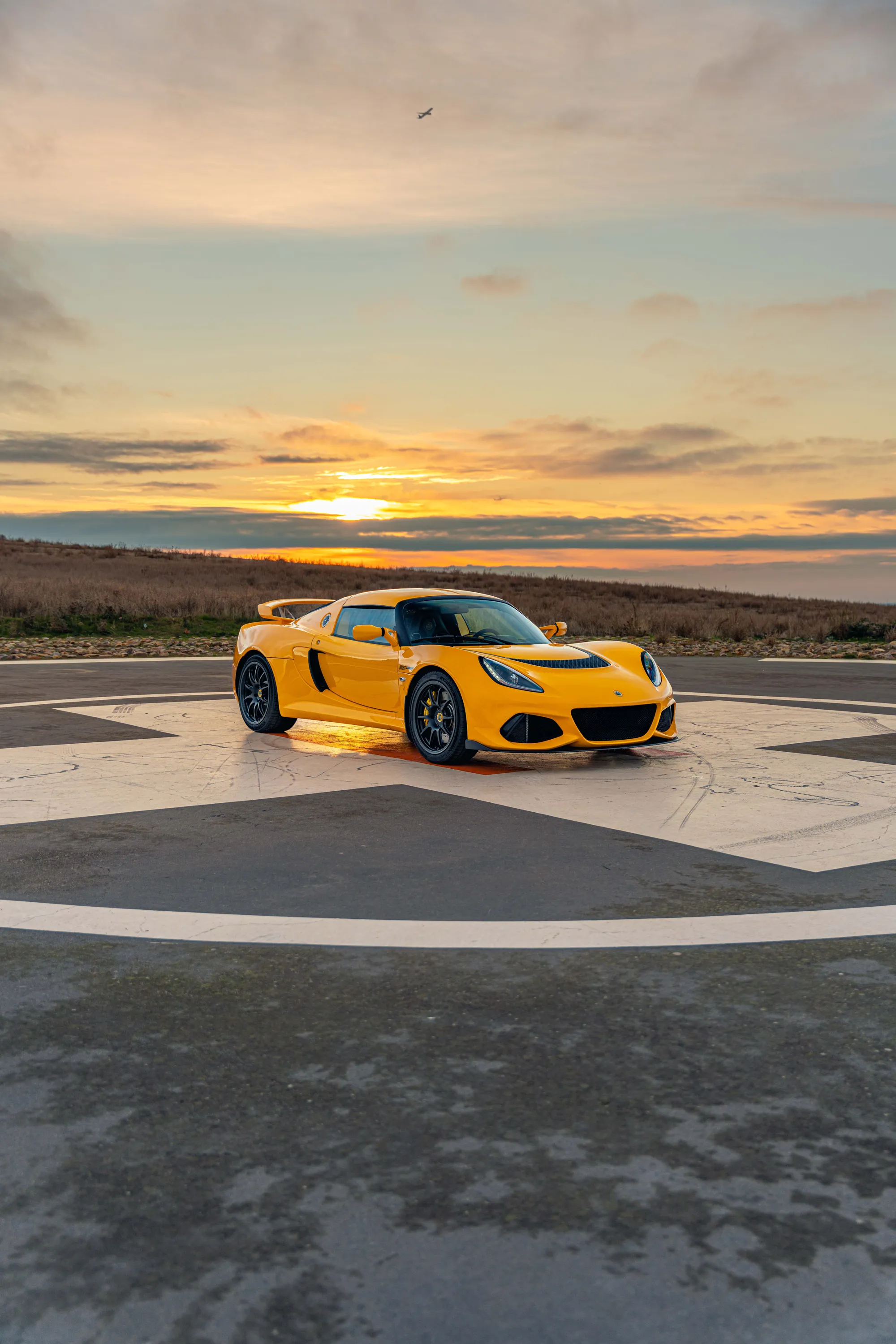 The Exige alone on an empty headland at sunset