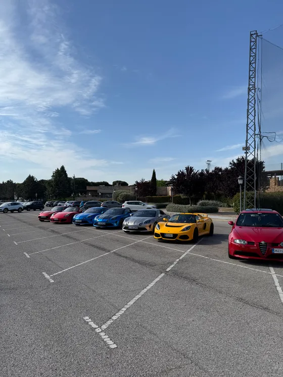 The Exige in a line of sports cars across a wide car park